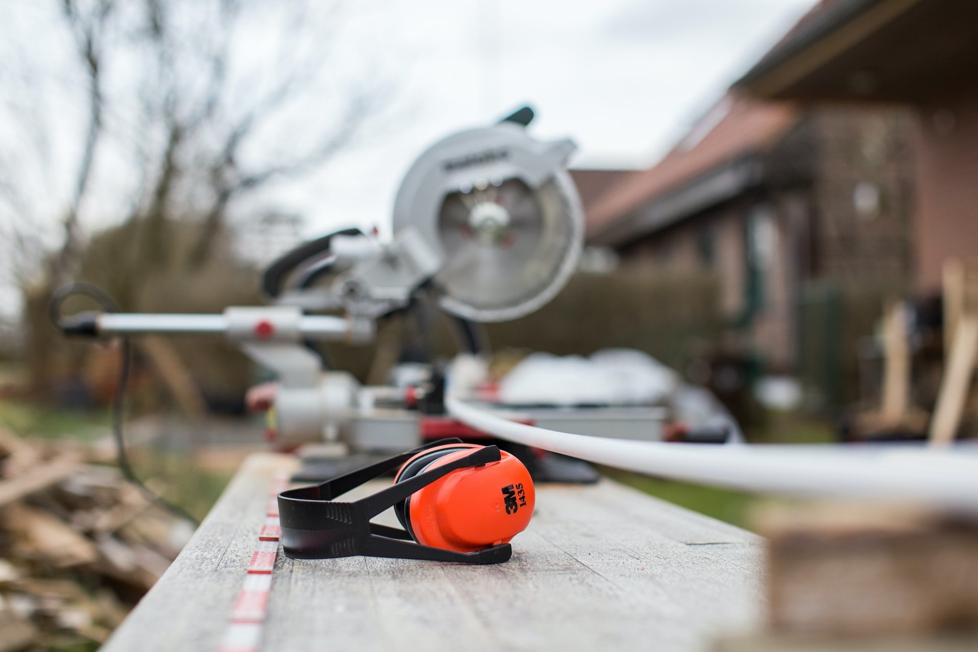 A Chop saw with ear defenders near